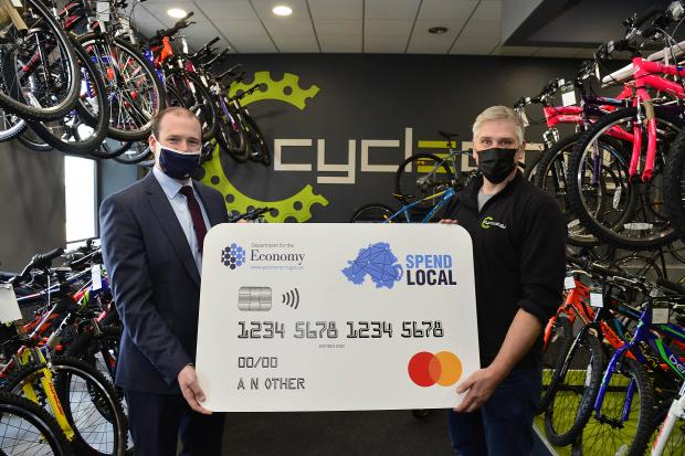 Economy Minister Gordon Lyons with Alistair Robinson, owner of bicycle shop Cycleology.